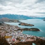 aerial photography of white houses near body of water under white clouds at daytime